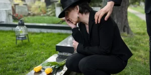 woman crying near grave